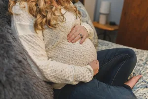 Pregnant woman sitting in couch